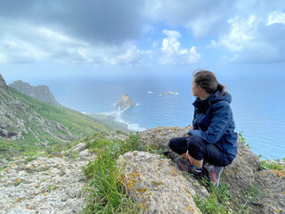 Poster - Woman sitting on cliff edge, gazing at water, Tenerife trip