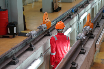 Professional technician worker hold light tube to check and maintenance part of train in electrical or metro train factory.