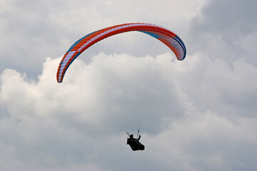 Poster - Paraglider flying in a cloudy sky	