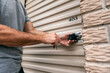 © Sean Locke/Stocksy - Storage: Man Unlocking Padlock On Unit