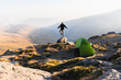 © Diego Martin/Stocksy - Traveler with tent in mountainous terrain