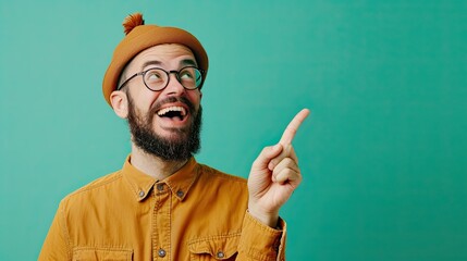 Wall Mural - Happy and funny person with a great idea, finger pointing up, plain green background, copy space