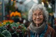 A joyful elderly Asian woman with glasses, smiling in a greenhouse amongst various plants