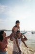 © Pedro Merino/Stocksy - Balinese family having fun at the beach