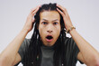 © peopleimages.com - African man, dreadlocks and wow in studio for news, gossip or announcement by white background. Male person, shock and surprise with omg reaction, mind blown and speechless expression with emotion
