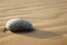 : Single Stone On Smooth Sand Beach