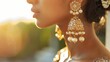 Traditional Indian jhumka earrings adorned with pearls and stones on a woman, captured in the warm glow of sunset. Cultural beauty and fashion concept