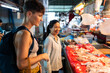 © Alvaro Lavin/Stocksy - Women at food market.