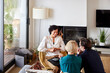 © ALTO IMAGES/Stocksy - Financial advisor discussing with couple at home
