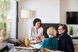 © ALTO IMAGES/Stocksy - Couple discussing home finance with female advisor