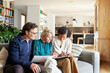 © ALTO IMAGES/Stocksy - Couple and financial advisor doing paperwork at home