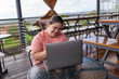 © Leonardo Borges Nuñez/Stocksy - Woman smiling while using her laptop