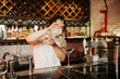 Skilled Bartender Pouring a Cocktail in a Modern Bar