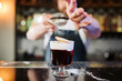 Professional Bartender Sprinkling Sugar on Craft Cocktail