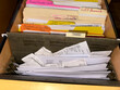 © Raymond Forbes LLC/Stocksy - Receipt in file cabinet drawer for taxes UGC
