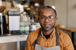 © Oleksii Syrotkin/Stocksy - Smiling Café Owner in Apron