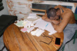 © Oleksii Syrotkin/Stocksy - Businessman Asleep Amid Paperwork