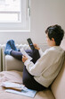 © Duet Postscriptum/Stocksy - Young woman pays heating bill with smartphone