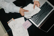 © EASY 2 SHOOT/Stocksy - Close-Up of a Woman Sorting Through Paperwork at Her Home Office Desk