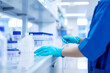 person in uniform and blue laboratory gloves handling clinical laboratory material