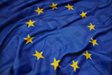 Fototapeta  - waving colorful national flag of european union on a euro money banknotes background. finance concept.