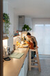 © Santi Nuñez/Stocksy - Happy family cooking together