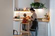 © Santi Nuñez/Stocksy - Happy family cooking together