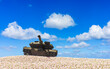Armored Tank Dominating a Field of Flowers under a Bright Blue Sky with Clouds