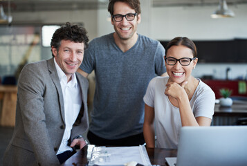 Leinwandbilder - People, desk and portrait with smile for team in office for meeting with planning in business. Businesspeople, table and laptop with collaboration with technology for company, teamwork and happy