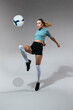 © BONNINSTUDIO/Stocksy - Active woman kicking ball in studio