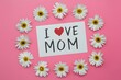 Photo Spring flowers and I Love Mom note on pink background