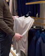© Elena Kharichkina/Stocksy - Man shopping in a men's clothing boutique