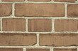 Brick wall, mortar and closeup for masonry construction, building and texture materials with paste.Cement, concrete and block shape clay with cracks or dents on solid surface or design wallpaper