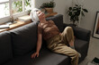 © Clique Images/Stocksy - Mature Woman Relaxing On Sofa
