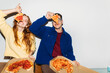 © Studio Firma/Stocksy - Couple posing with pizza slices