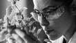In a monochromatic portrait a scientist is shown meticulously examining a plant specimen their focused expression highlighting the importance of attention to detail in their field .