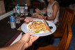 © Alvaro Lavin/Stocksy - Person holding plate of Pad Thai.
