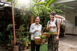 © Alvaro Lavin/Stocksy - Women holding baskets with fresh vegetables.