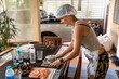 © Alvaro Lavin/Stocksy - Woman serving food on the table.