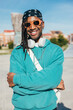 © VICTOR TORRES/Stocksy - Stylish urban man with sunglasses and headphones