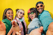 © VICTOR TORRES/Stocksy - Cheerful young friends taking a group selfie together