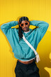 © VICTOR TORRES/Stocksy - Fashionable black man in sunglasses against yellow background