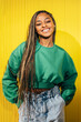 © VICTOR TORRES/Stocksy - Joyful Black Woman Against Yellow Background