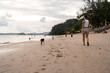 © Alvaro Lavin/Stocksy - Woman walking on the beach.