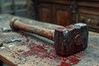 Conceptual image a hammer in blood on the table. The concept of committed crime, murder, torture and physical injury