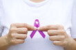woman with purple ribbon For patients with breast and cervical cancer
