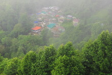 Panorama Of Foggy And Cloudy Mountain Village, On The Slopes Of Himalaya Mountains Near Darjeeling Hill Station In Monsoon Season, West Bengal, India
