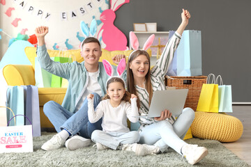 Sticker - Happy family in bunny ears with laptop shopping online at home. Easter Sale