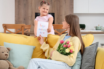 Sticker - Little girl greeting her mom with Mothers Day with greeting card in room