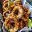 Crispy fried calamari rings served with a wedge of lime